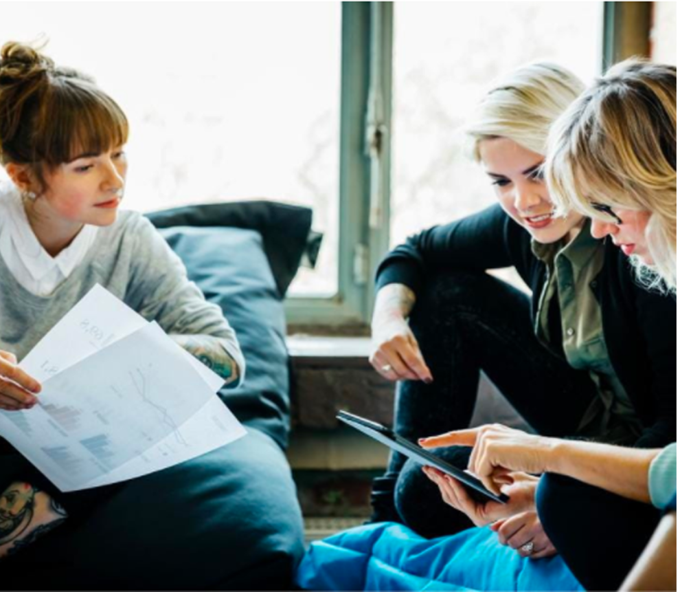 Coworkers making plans with tablet and papers